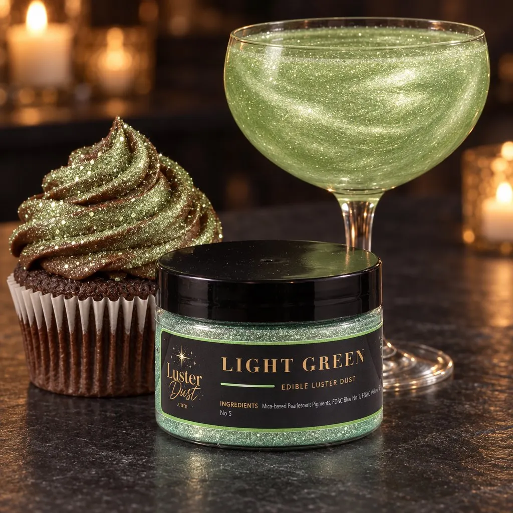Light Green glitter drink in a coupe with a jar of light green luster dust and a cupcake topped with light green edible glitter on a candlelit table
