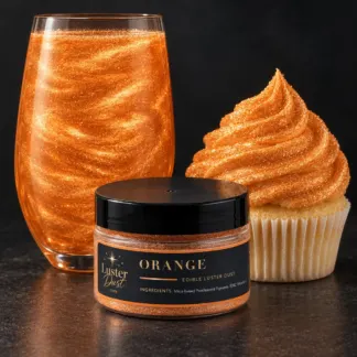 Orange edible luster dust in a 50 g jar beside a orange glitter drink and a cupcake coated in orange edible glitter