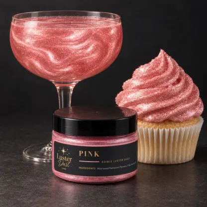 Pink edible luster dust in a 50 g jar beside a pink glitter drink and a cupcake coated in pink edible glitter