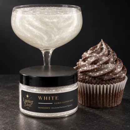 White edible luster dust in a 50 g jar beside a white glitter drink and a cupcake coated in white edible glitter